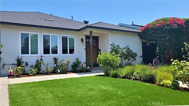 143 Warren Ave, Santa Paula, CA 93060 - view of front facade featuring a front yard, roof with shingles, and stucco siding