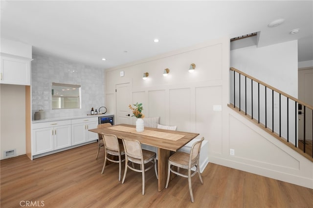 16221 Orizaba Ave, Paramount, CA 90723 - dining area with light wood finished floors, stairway, recessed lighting, and a decorative wall