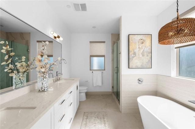 16221 Orizaba Ave, Paramount, CA 90723 - bathroom featuring double vanity, a freestanding bath, a shower stall, and tile patterned floors