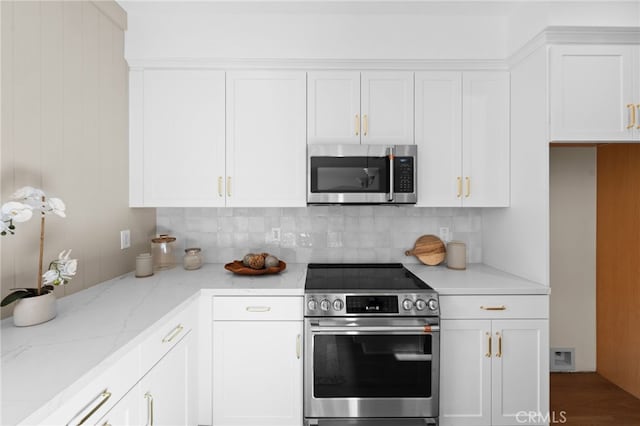 16221 Orizaba Ave, Paramount, CA 90723 - kitchen with stainless steel appliances, white cabinets, backsplash, and light stone counters