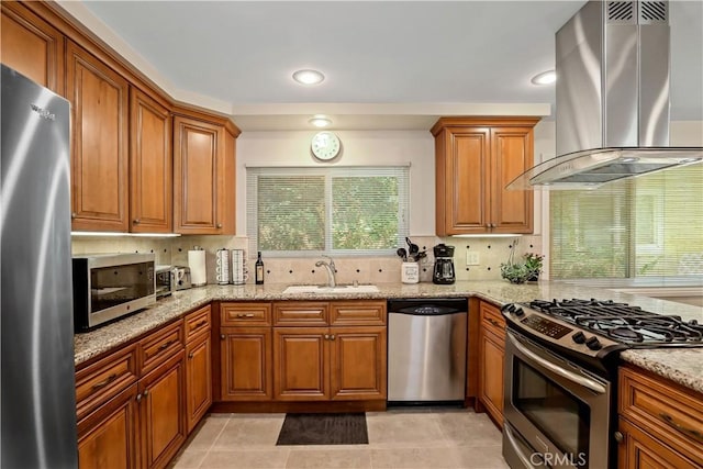 617 Iris Ave, Corona Del Mar, CA 92625 - kitchen with stainless steel appliances, wall chimney exhaust hood, brown cabinetry, light stone counters, and recessed lighting