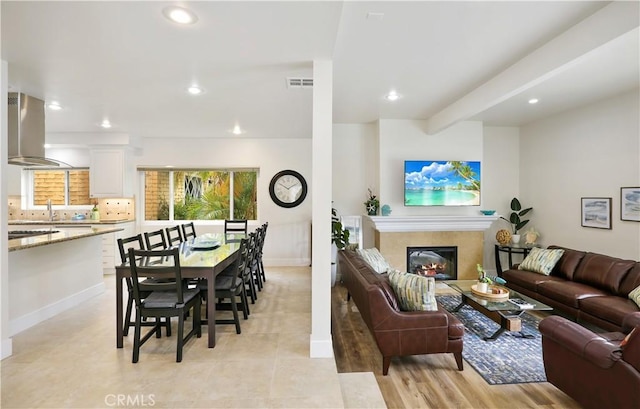 617 Iris Ave, Corona Del Mar, CA 92625 - living area featuring recessed lighting, a glass covered fireplace, and light tile patterned flooring