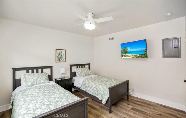 617 Iris Ave, Corona Del Mar, CA 92625 - bedroom featuring electric panel, wood finished floors, and ceiling fan
