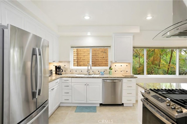 617 Iris Ave, Corona Del Mar, CA 92625 - kitchen featuring appliances with stainless steel finishes, island range hood, white cabinetry, tasteful backsplash, and recessed lighting
