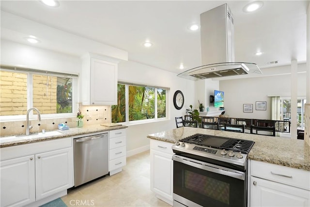 617 Iris Ave, Corona Del Mar, CA 92625 - kitchen featuring stainless steel appliances, island exhaust hood, light stone countertops, recessed lighting, and backsplash