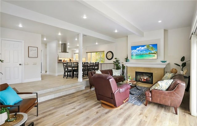617 Iris Ave, Corona Del Mar, CA 92625 - living area with a high end fireplace, beamed ceiling, light wood-style flooring, and recessed lighting