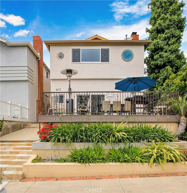 617 Iris Ave, Corona Del Mar, CA 92625 - view of front of property featuring stucco siding and a chimney
