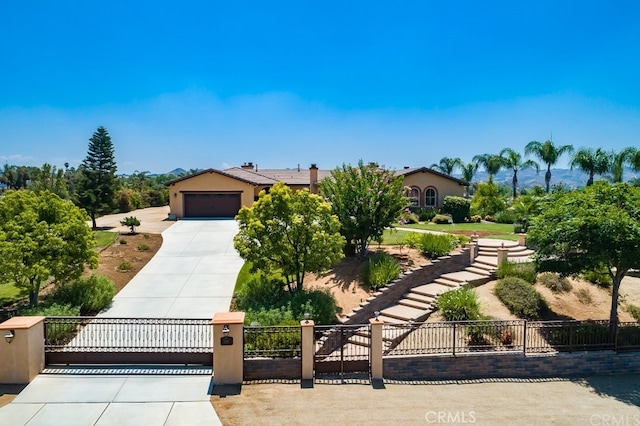 16767 Eagle Peak Rd, Riverside, CA 92504 - view of front of property with a gate, concrete driveway, a garage, and stucco siding