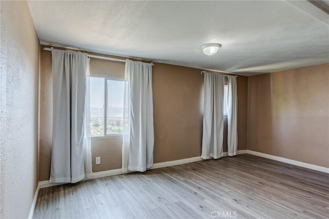 35050 Margo Rd, Lake Elsinore, CA 92530 - empty room with wood finished floors and a textured ceiling