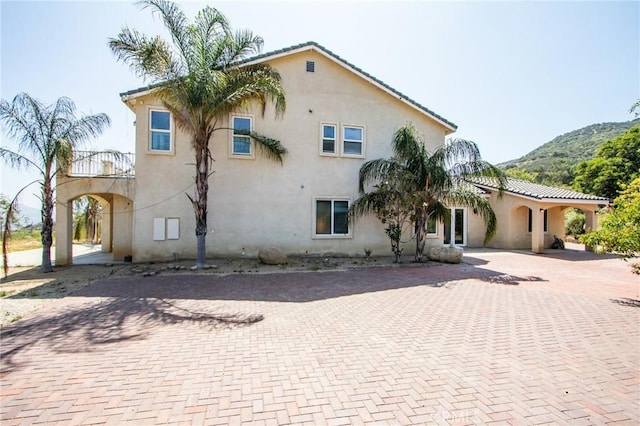 35050 Margo Rd, Lake Elsinore, CA 92530 - view of front of house with stucco siding, a mountain view, and decorative driveway