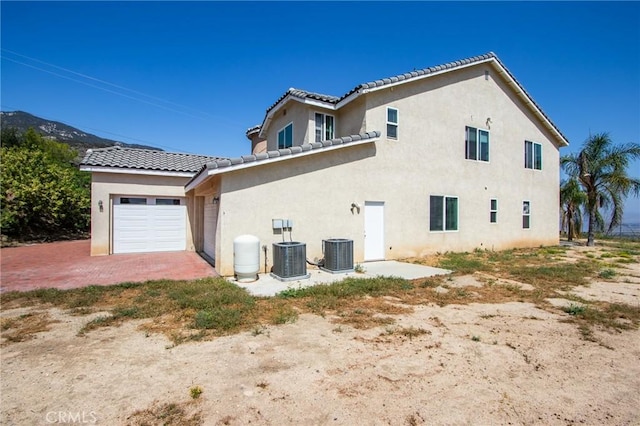 35050 Margo Rd, Lake Elsinore, CA 92530 - view of property exterior featuring stucco siding, an attached garage, and a tile roof