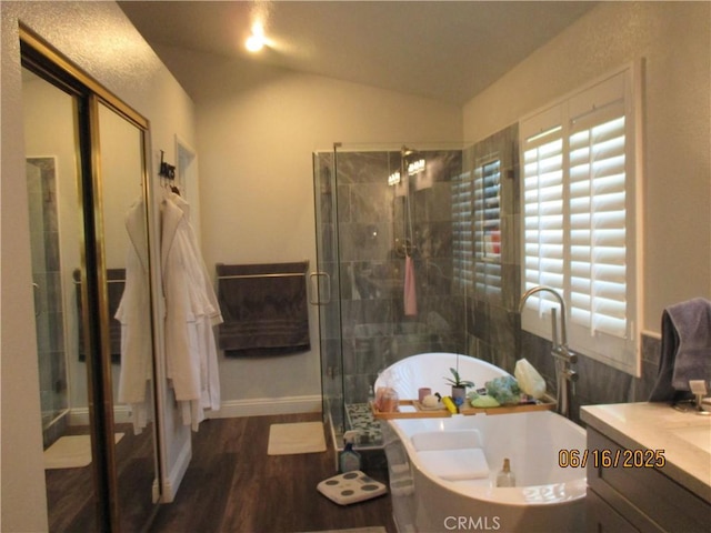 9244 Whitting Way, Riverside, CA 92508 - bathroom featuring vanity, lofted ceiling, a soaking tub, wood finished floors, and a stall shower