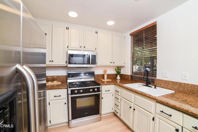 307 E Walnut Ave Unit D, Monrovia, CA 91016 - kitchen with appliances with stainless steel finishes, white cabinetry, and recessed lighting
