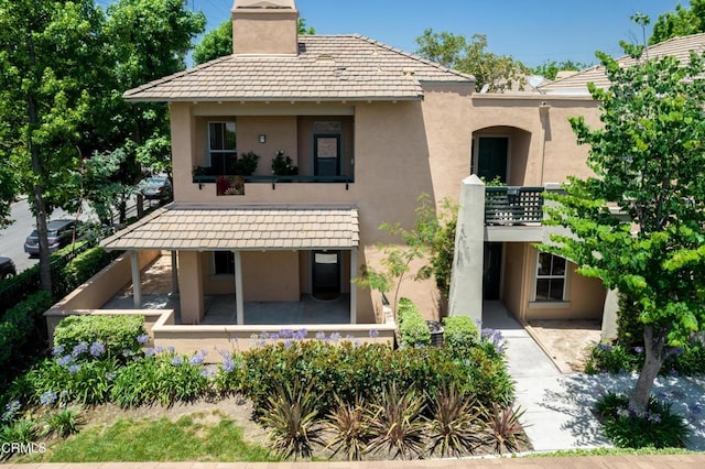 307 E Walnut Ave Unit D, Monrovia, CA 91016 - rear view of house featuring stucco siding, a chimney, and a balcony