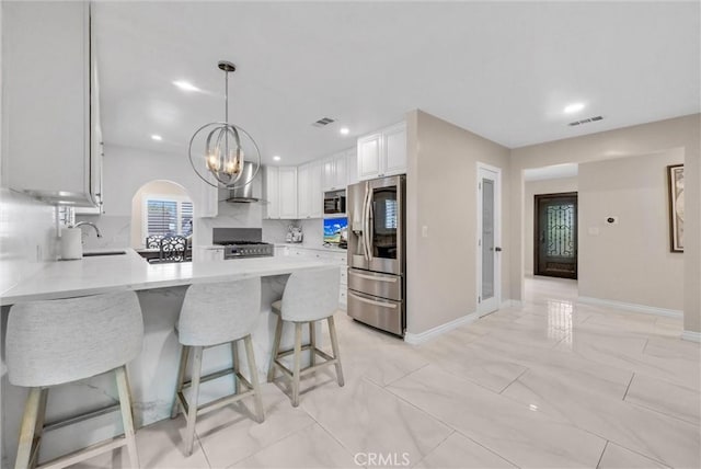 1115 E Sierra Madre Ave, Glendora, CA 91741 - kitchen with appliances with stainless steel finishes, a peninsula, tasteful backsplash, white cabinetry, and a kitchen bar