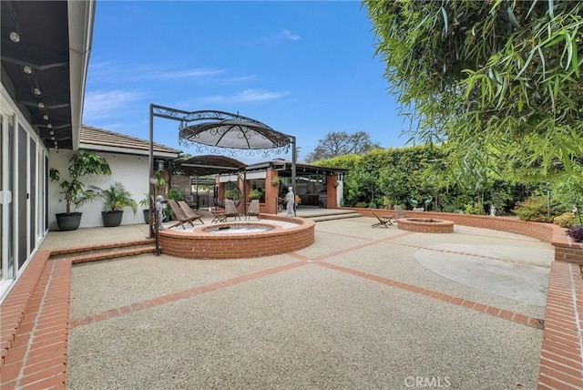 1115 E Sierra Madre Ave, Glendora, CA 91741 - view of patio / terrace featuring an outdoor fire pit and an in-ground hot tub