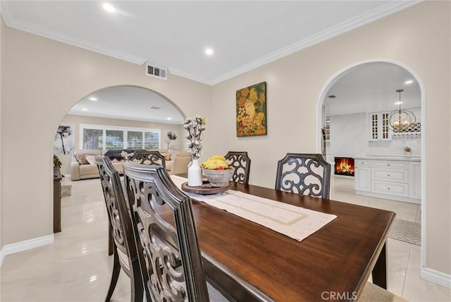 1115 E Sierra Madre Ave, Glendora, CA 91741 - dining room featuring arched walkways, recessed lighting, light tile patterned floors, and ornamental molding