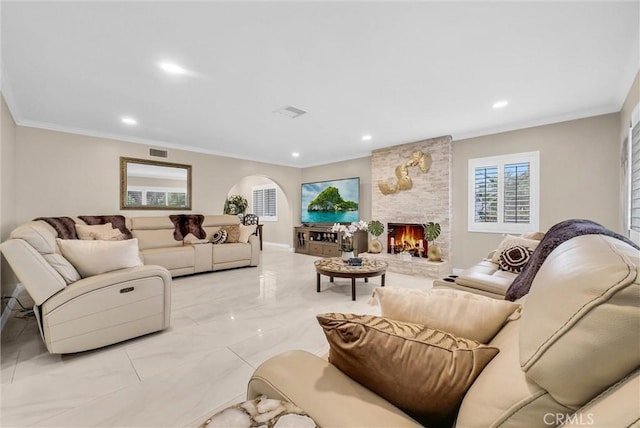 1115 E Sierra Madre Ave, Glendora, CA 91741 - living room featuring arched walkways, crown molding, a stone fireplace, recessed lighting, and light marble finish flooring