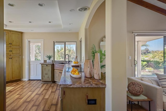 12870 Circulo Dardo, San Diego, CA 92128 - kitchen featuring light wood-style floors, a raised ceiling, arched walkways, and recessed lighting