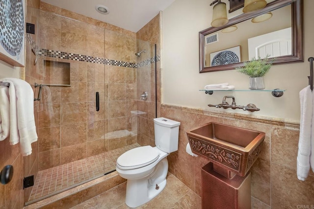 12870 Circulo Dardo, San Diego, CA 92128 - bathroom featuring tile walls, a stall shower, a wainscoted wall, and tile patterned floors