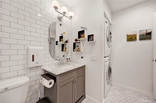 1118 Valencia St Unit 120, Los Angeles, CA 90015 - bathroom featuring stacked washer / dryer, vanity, and tile patterned flooring
