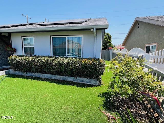1900 Piedmont St, Oxnard, CA 93035 - view of side of property with solar panels and stucco siding