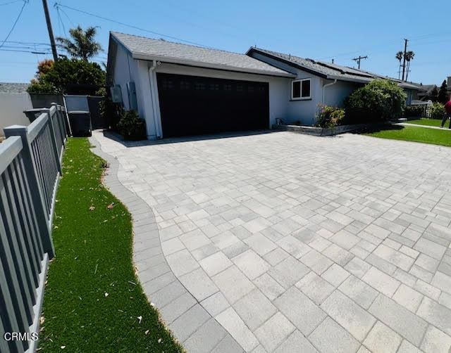 1900 Piedmont St, Oxnard, CA 93035 - single story home featuring decorative driveway, a garage, stucco siding, and solar panels