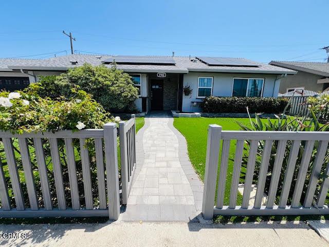 1900 Piedmont St, Oxnard, CA 93035 - ranch-style house with a fenced front yard, solar panels, and stucco siding