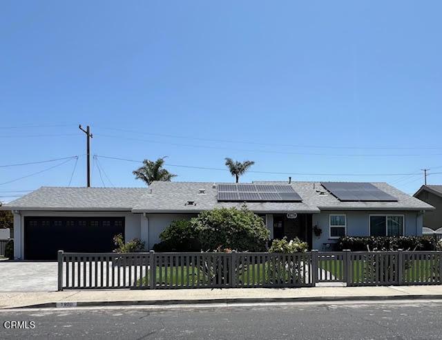 1900 Piedmont St, Oxnard, CA 93035 - ranch-style home featuring a fenced front yard, an attached garage, concrete driveway, and roof mounted solar panels