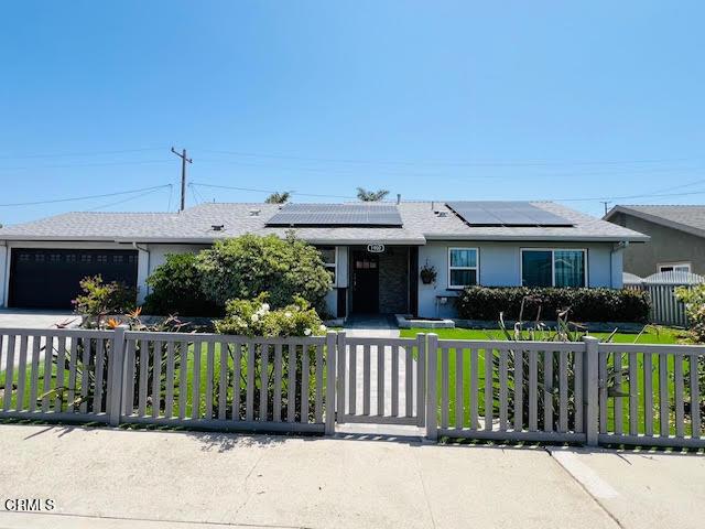 1900 Piedmont St, Oxnard, CA 93035 - single story home with a fenced front yard, an attached garage, concrete driveway, solar panels, and roof with shingles
