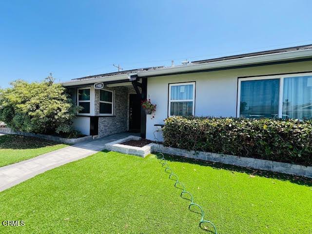 1900 Piedmont St, Oxnard, CA 93035 - view of front of house featuring a front lawn, stone siding, and stucco siding