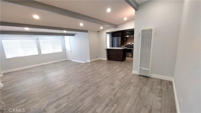 8649 Cantaloupe Ave, Panorama City, CA 91402 - unfurnished living room featuring a heating unit, beamed ceiling, light wood finished floors, and recessed lighting