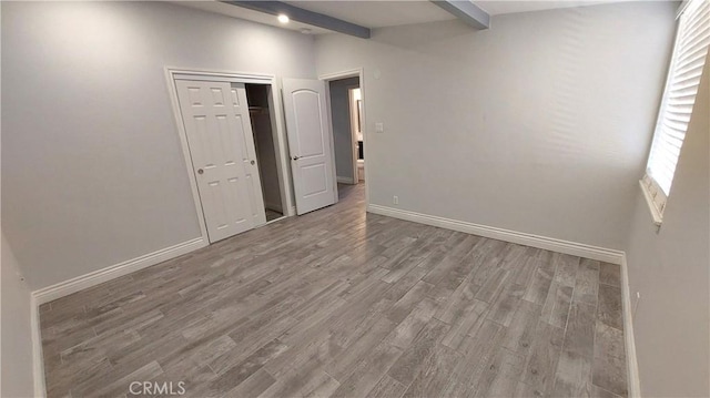 8649 Cantaloupe Ave, Panorama City, CA 91402 - spare room featuring wood finished floors and beam ceiling