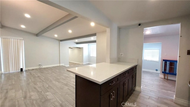 8649 Cantaloupe Ave, Panorama City, CA 91402 - kitchen featuring healthy amount of natural light, light countertops, light wood-style floors, open floor plan, and beamed ceiling