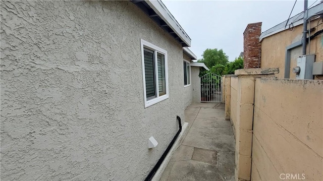 8649 Cantaloupe Ave, Panorama City, CA 91402 - view of side of home featuring stucco siding and a gate