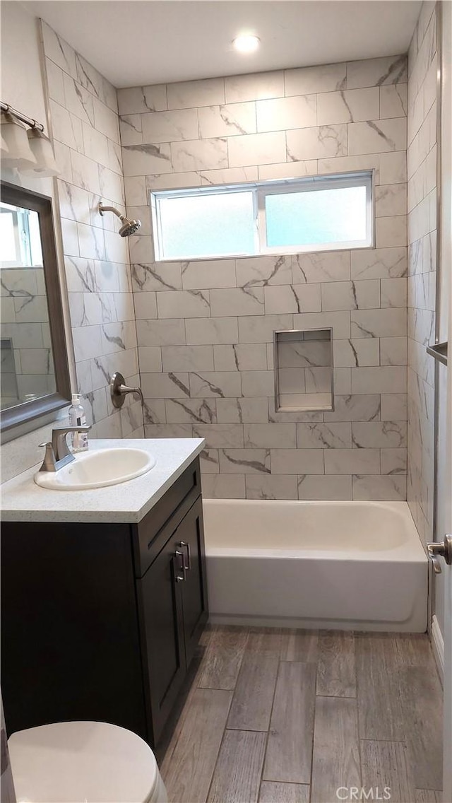 8649 Cantaloupe Ave, Panorama City, CA 91402 - full bathroom featuring vanity, plenty of natural light, shower / bathtub combination, and wood finished floors