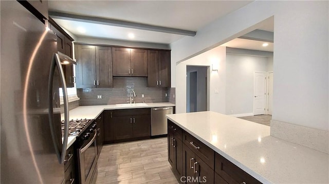 8649 Cantaloupe Ave, Panorama City, CA 91402 - kitchen with stainless steel appliances, dark brown cabinets, tasteful backsplash, light wood-type flooring, and light stone countertops