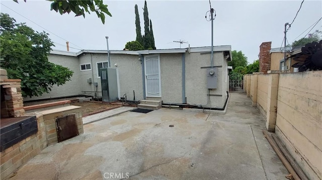 8649 Cantaloupe Ave, Panorama City, CA 91402 - back of property featuring stucco siding, a patio, and entry steps