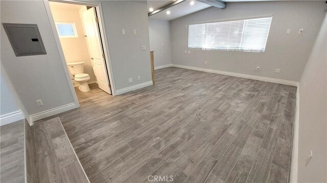 8649 Cantaloupe Ave, Panorama City, CA 91402 - unfurnished bedroom featuring electric panel, wood finished floors, and connected bathroom