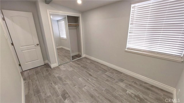 8649 Cantaloupe Ave, Panorama City, CA 91402 - unfurnished bedroom with wood finished floors, a closet, and vaulted ceiling