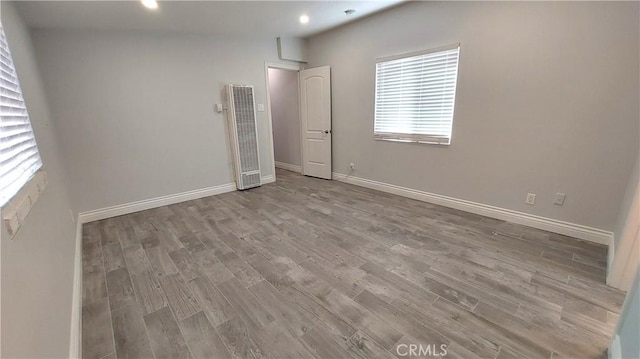 8649 Cantaloupe Ave, Panorama City, CA 91402 - empty room featuring a heating unit, wood finished floors, and recessed lighting