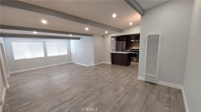 8649 Cantaloupe Ave, Panorama City, CA 91402 - unfurnished living room with beam ceiling, light wood-style floors, a heating unit, and recessed lighting