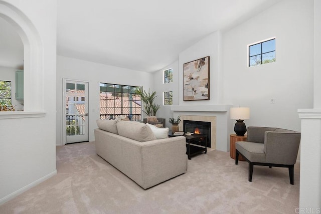 3649 Azure Cir, Carlsbad, CA 92008 - living area featuring a tiled fireplace, light carpet, plenty of natural light, arched walkways, and vaulted ceiling