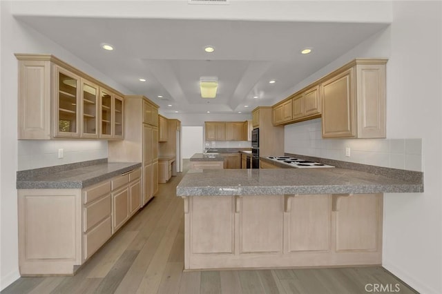 6041 Calle Mirador, Yorba Linda, CA 92886 - kitchen with light brown cabinetry, a tray ceiling, a peninsula, light wood-style floors, and white cooktop