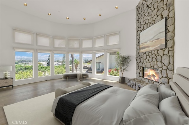 6041 Calle Mirador, Yorba Linda, CA 92886 - bedroom with a fireplace, wood finished floors, a towering ceiling, and recessed lighting