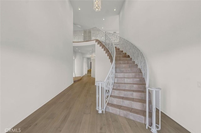 6041 Calle Mirador, Yorba Linda, CA 92886 - staircase featuring hardwood / wood-style floors, a chandelier, recessed lighting, and a towering ceiling