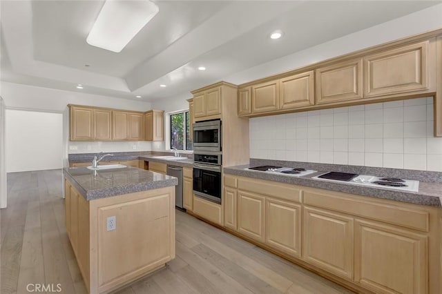 6041 Calle Mirador, Yorba Linda, CA 92886 - kitchen with light brown cabinetry, appliances with stainless steel finishes, a tray ceiling, an island with sink, and backsplash