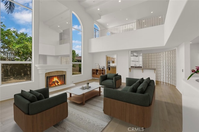 6041 Calle Mirador, Yorba Linda, CA 92886 - living room featuring wood finished floors, a glass covered fireplace, plenty of natural light, a towering ceiling, and recessed lighting