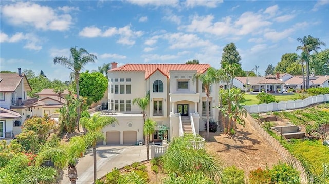 6041 Calle Mirador, Yorba Linda, CA 92886 - mediterranean / spanish house with stucco siding, concrete driveway, a residential view, a garage, and a chimney