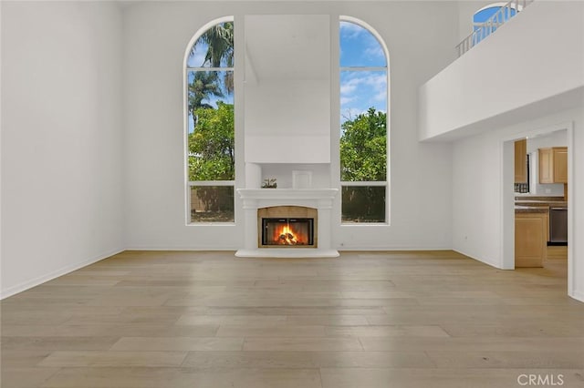 6041 Calle Mirador, Yorba Linda, CA 92886 - unfurnished living room featuring plenty of natural light, light wood finished floors, and a glass covered fireplace